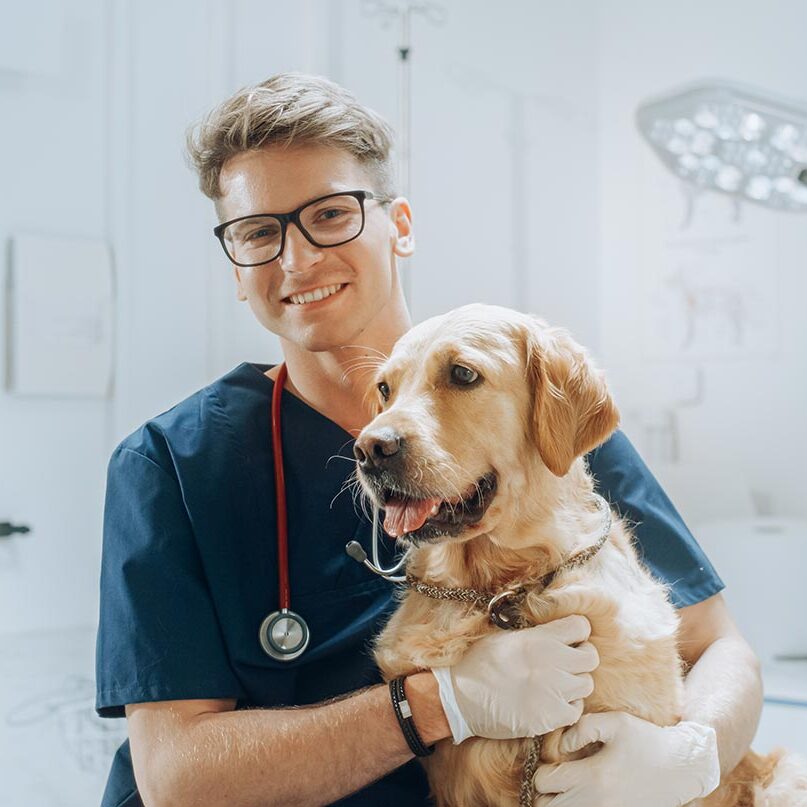 veterinarian posing for a photo with dog