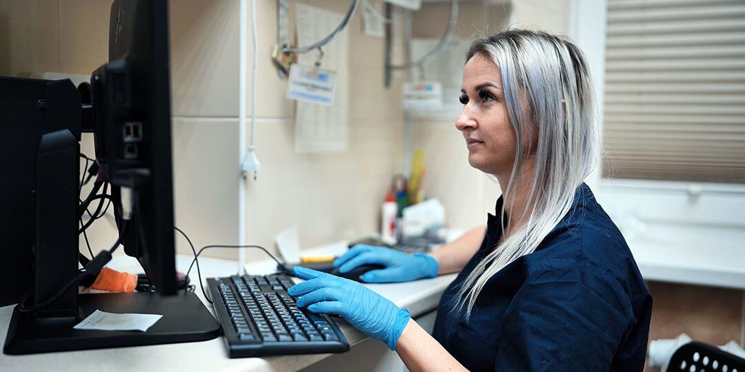 Veterinary Assistant On Computer